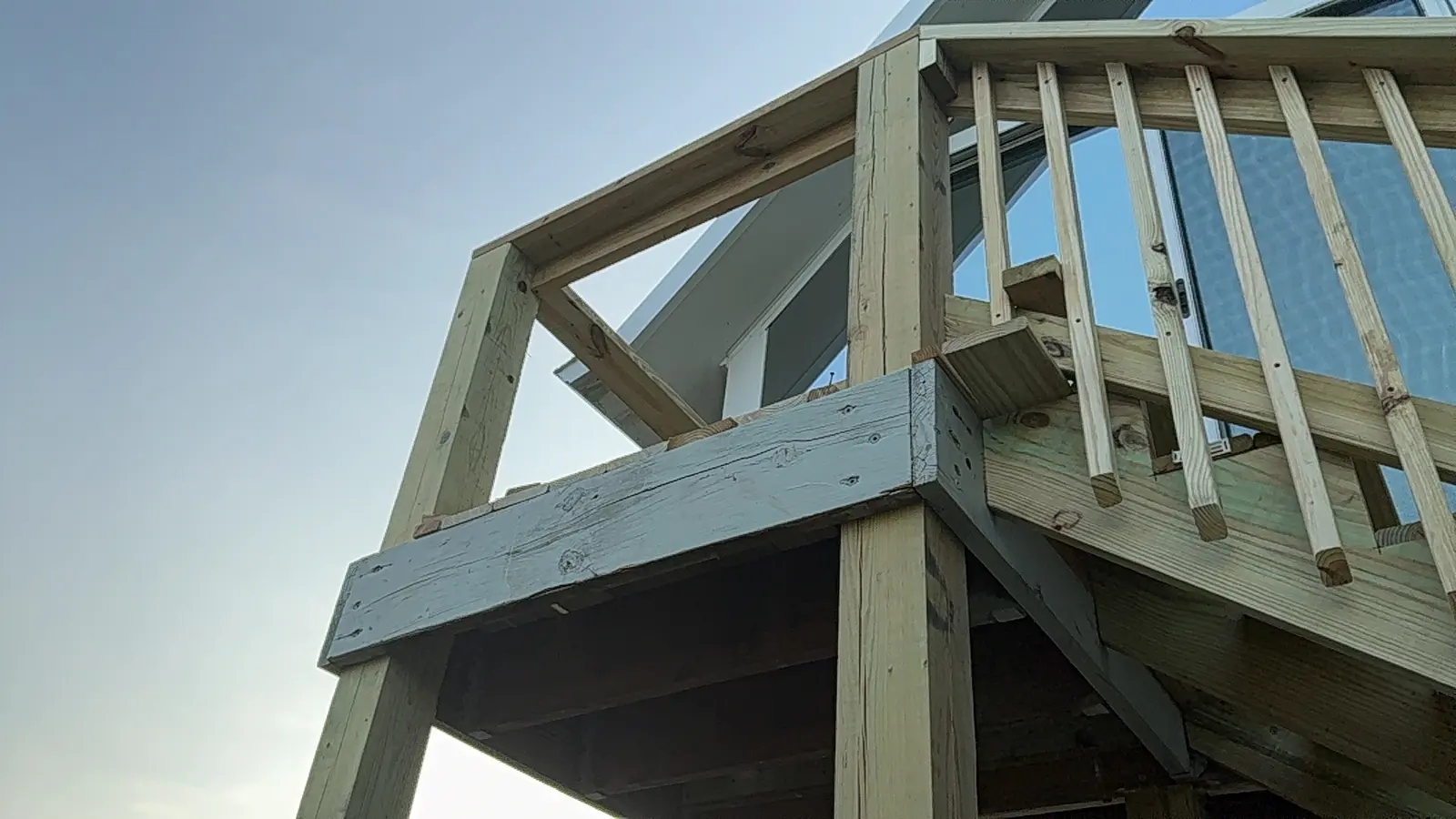 Wood posts, beams and railing viewed from below