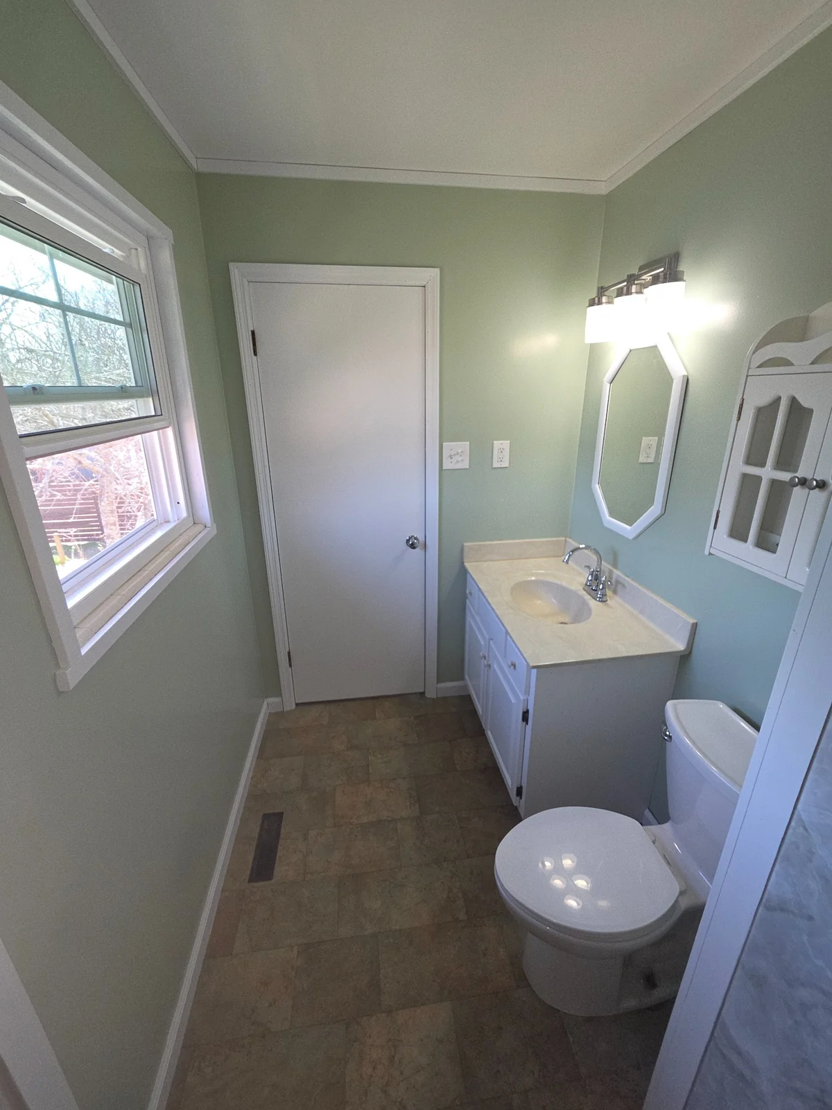 Completed bathroom with vanity, mirror and shower