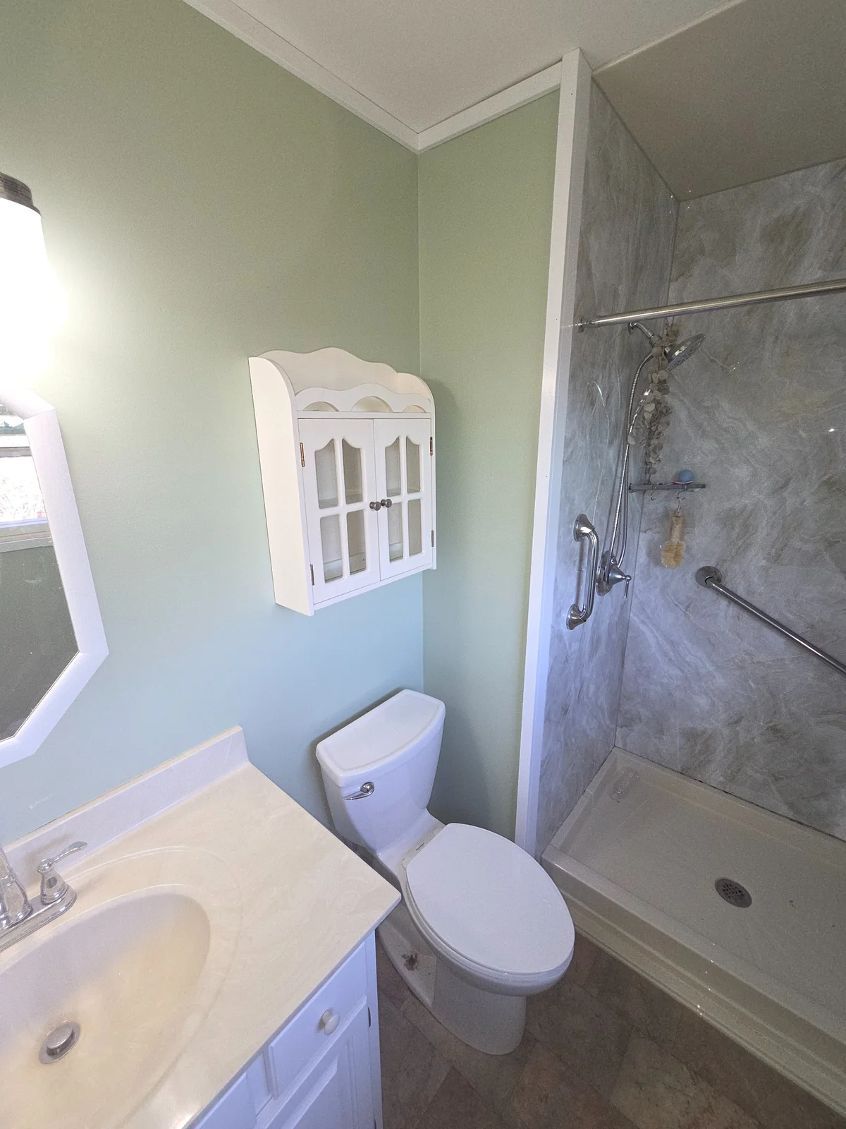 Bathroom vanity and shower viewed from the doorway