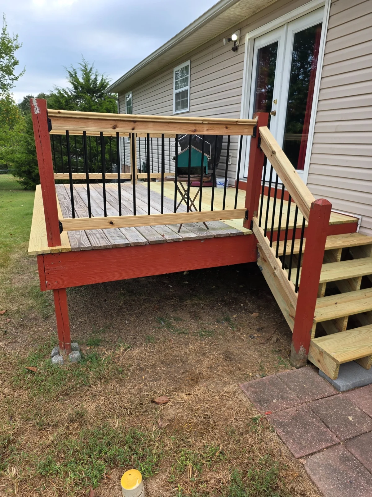 Fresh wood decking alongside retained painted framing