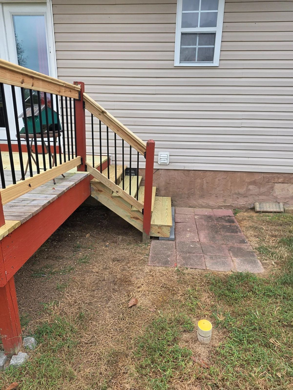 New wood stair treads connecting the deck to the yard
