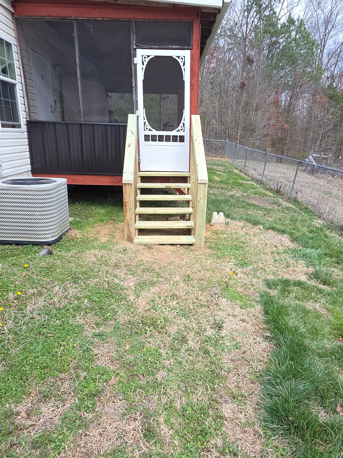 Finished wood steps outside a screened porch