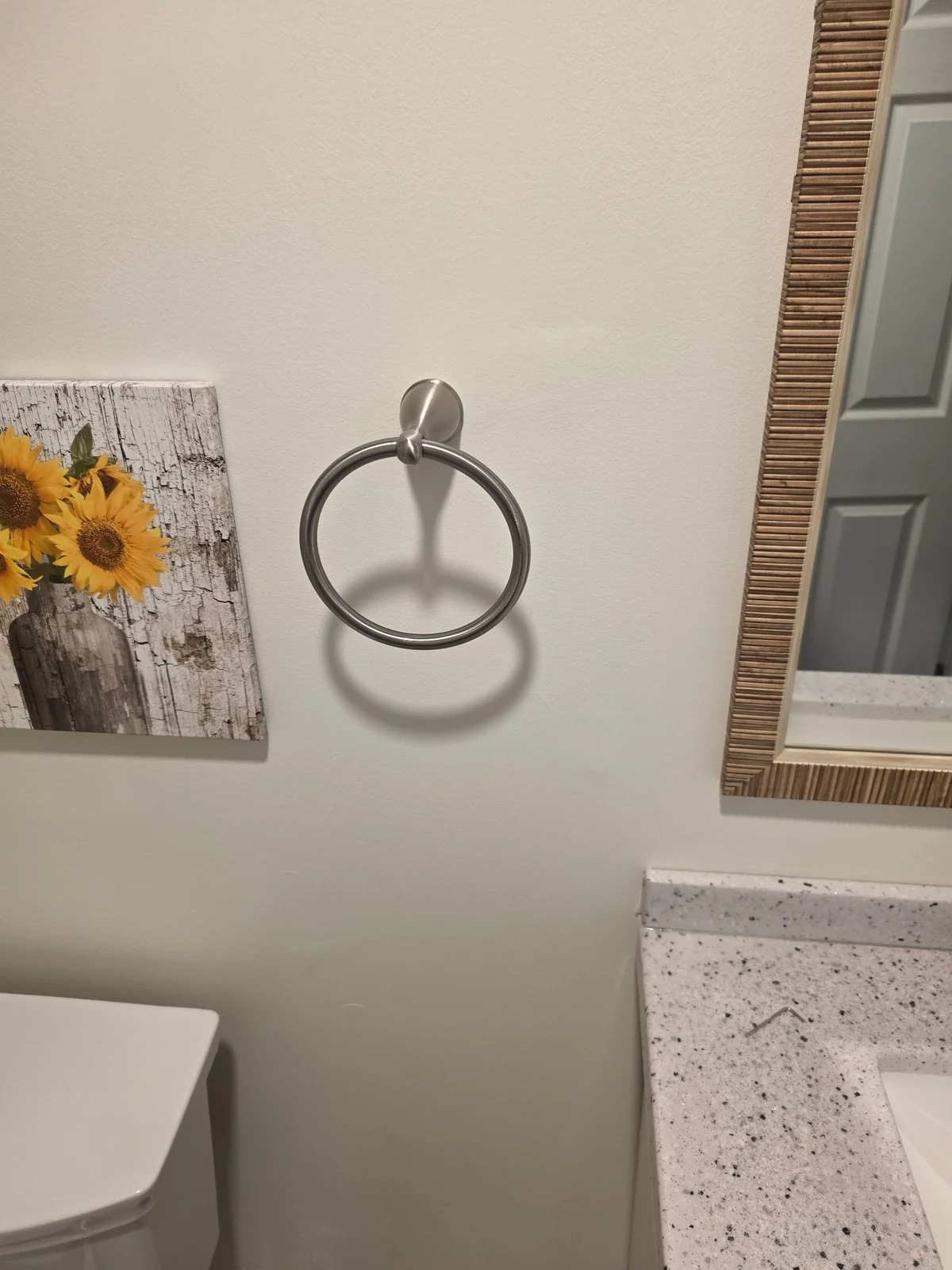 Bathroom towel ring mounted beside a vanity